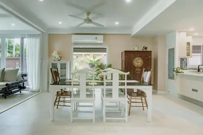 a kitchen and dining room with a white table and chairs at Koson Elegant 3 Bedroom Villa in Rawai Beach