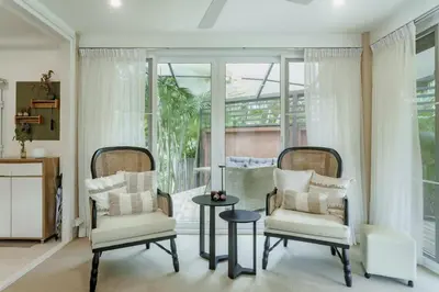 a living room with two chairs and a table at Koson Elegant 3 Bedroom Villa in Rawai Beach