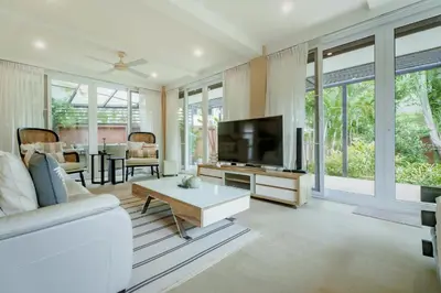 a living room with a white couch and a tv at Koson Elegant 3 Bedroom Villa in Rawai Beach