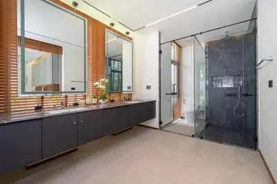 a bathroom with two sinks and a shower at Zenithy Morden Pool and Garden Villa near Bangtao Beach in Ban Pak Lak