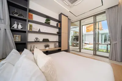 a bedroom with a white bed and a large window at Zenithy Morden Pool and Garden Villa near Bangtao Beach in Ban Pak Lak