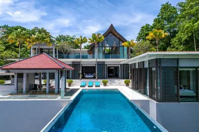 an exterior view of a house with a swimming pool at Villa Elegance Luxury Ocean View Pool Villa with Breakfas & Daily Maid Service in Ko Lek
