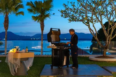 a man standing in front of a machine with a table at Villa Elegance Luxury Ocean View Pool Villa with Breakfas & Daily Maid Service in Ko Lek