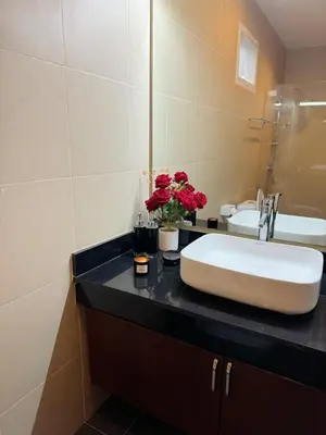 a bathroom with a sink and two sinks at shine bright villa in Ban Saiyuan (1)