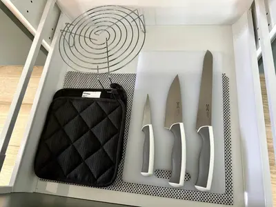 a drawer filled with knives and a fan at Beatiful titlhalo apartment in Nai Yang Beach