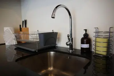 a kitchen counter with a sink and a sink at A Well Equipped Condo near Karon Beach in Karon Beach