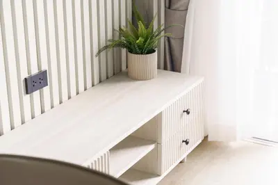 a white console table with a potted plant on it at The Ozone Scarlet Grey Golf View Bangtao in Laguna Phuket