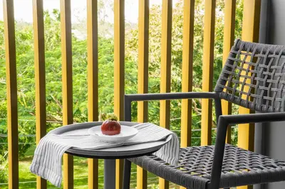 a chair with a plate with a fruit on it at The Ozone Scarlet Grey Golf View Bangtao in Laguna Phuket