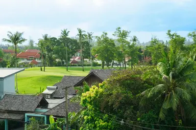a view of a golf course with trees and houses at The Ozone Scarlet Grey Golf View Bangtao in Laguna Phuket