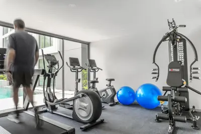 a man in a gym with several exercise bikes at The Ozone Scarlet Grey Golf View Bangtao in Laguna Phuket