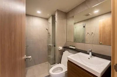a bathroom with a toilet and a sink and a shower at RJ Space in Ban Thalat Choeng Thale