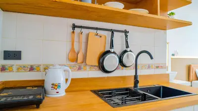 a kitchen counter with a sink and utensils on the wall at Quiet & Comfy studio - Walk to Rawai Beach - 