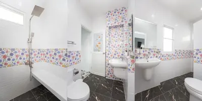 a white bathroom with a sink and a toilet at Seaside house in Ban Thalat Choeng Thale