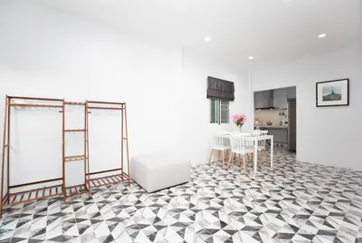 a living room with a black and white checkered floor at Seaside house in Ban Thalat Choeng Thale
