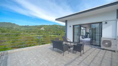 a patio with a table and chairs on a balcony at 5BR Lucky Pool Villa Kathu Golf - 12 guest in Kathu