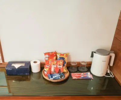 a glass table with chips and snacks on it at Salty Pearl Phuket 1 in Patong Beach