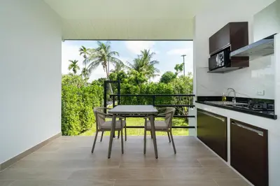 a kitchen and dining room with a table and chairs at DC Resident Phuket in Phuket Town