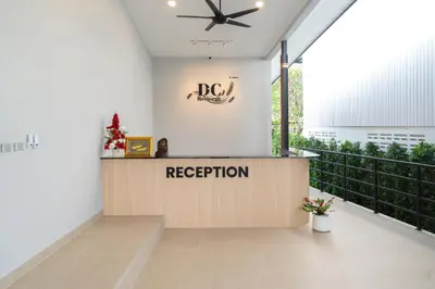 a reception area in a building with a ceiling fan at DC Resident Phuket in Phuket Town