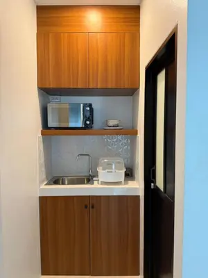 a small kitchen with a sink and a microwave at Veeyava Bangtao House in Surin Beach
