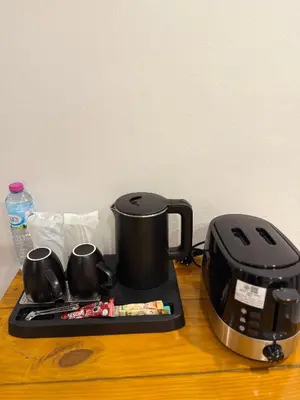 a coffee maker and a toaster on a table at Veeyava Bangtao House in Surin Beach