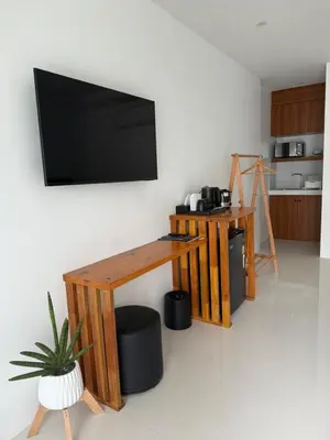 a living room with a flat screen tv on a wall at Veeyava Bangtao House in Surin Beach
