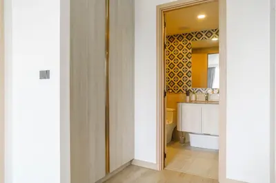 a room with a hallway with a kitchen at The Ozone Terracotta Art Golf View Bangtao in Laguna Phuket