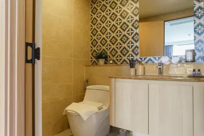 a bathroom with a toilet and a sink at The Ozone Terracotta Art Golf View Bangtao in Laguna Phuket