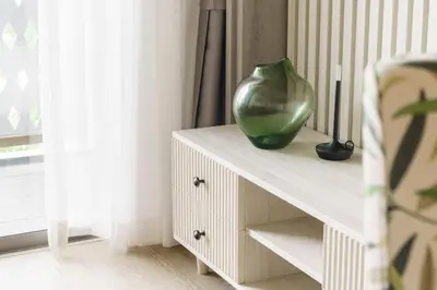 a green vase sitting on a table in a room at The Ozone Terracotta Art Golf View Bangtao in Laguna Phuket