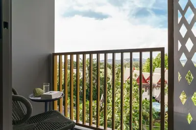 a balcony with a view of a resort at The Ozone Terracotta Art Golf View Bangtao in Laguna Phuket