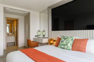 a bedroom with a large bed and a desk at The Ozone Terracotta Art Golf View Bangtao in Laguna Phuket