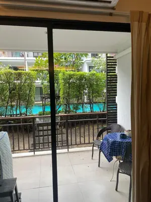 a patio with a table and chairs and a balcony at The title rawai in Ban Saiyuan (1)