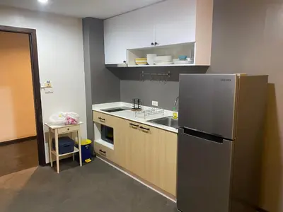 a kitchen with a stainless steel refrigerator and a sink at The title rawai in Ban Saiyuan (1)