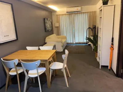 a room with a table and chairs and a couch at The title rawai in Ban Saiyuan (1)