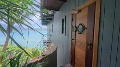 a room with a door and a view of the ocean at Salty Pearl Phuket 2 in Patong Beach
