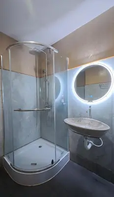 a bathroom with a sink and a glass shower at Salty Pearl Phuket 2 in Patong Beach