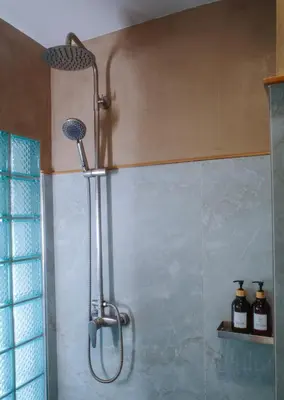 a shower with a shower head in a bathroom at Salty Pearl Phuket 2 in Patong Beach
