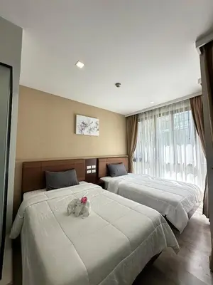 a bedroom with two beds with a stuffed animal on it at Condominium Royal Lee Airport Phuket30 in Ban Bo Han