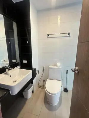 a bathroom with a white toilet and a sink at Condominium Royal Lee Airport Phuket30 in Ban Bo Han