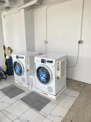 two washing machines sitting on top of each other in a room at Condominium Royal Lee Airport Phuket30 in Ban Bo Han