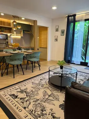 a living room with a couch and a table at Rinda House Patong 31 in Patong Beach