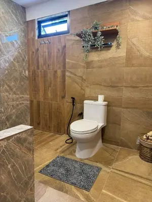 a bathroom with a toilet and a shower at Rinda House Patong 31 in Patong Beach