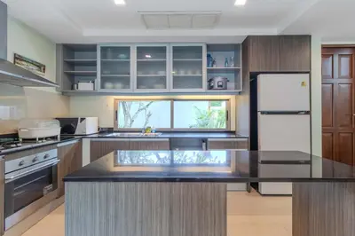 a kitchen with a refrigerator and a counter top at V241 3BR Peaceful Pool Villa, Garden & Jacuzzi in Koh Lone