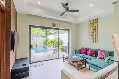 a living room with a couch and a table at V241 3BR Peaceful Pool Villa, Garden & Jacuzzi in Koh Lone