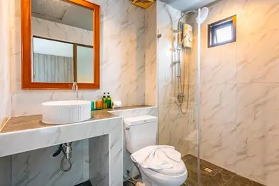 a bathroom with a toilet and a sink and a shower at The Outdoor Kata Hotel in Kata Beach