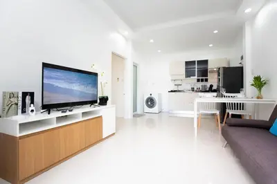 a living room with a large flat screen tv on a counter at Cozy houses AVTO near the Bang Tao beach in Ban Thalat Choeng Thale