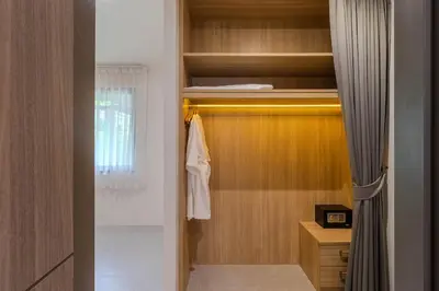 a room with a closet with a bed and a towel at V242 Prime Location 2BR with Pool&Garden Near Beach in Bang Tao Beach