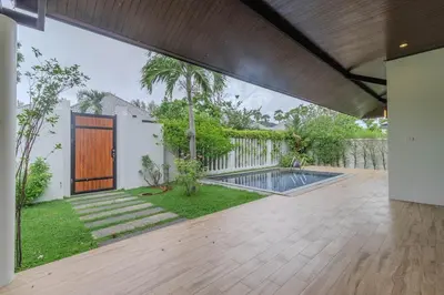 an external view of a house with a swimming pool at V242 Prime Location 2BR with Pool&Garden Near Beach in Bang Tao Beach