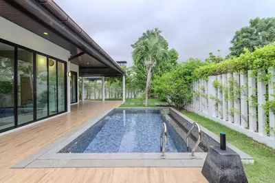 a swimming pool in the backyard of a house at V242 Prime Location 2BR with Pool&Garden Near Beach in Bang Tao Beach