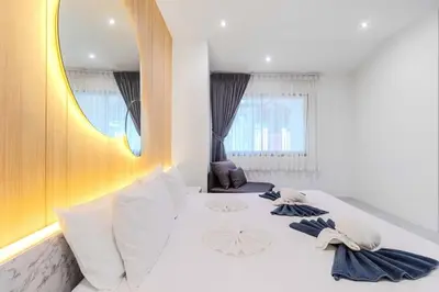 a white bed in a room with a mirror at V243 Quite 3BR Pool Villa Bathtub Near Beach in Bang Tao Beach