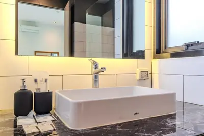 a bathroom with a large white sink and mirrors at V243 Quite 3BR Pool Villa Bathtub Near Beach in Bang Tao Beach